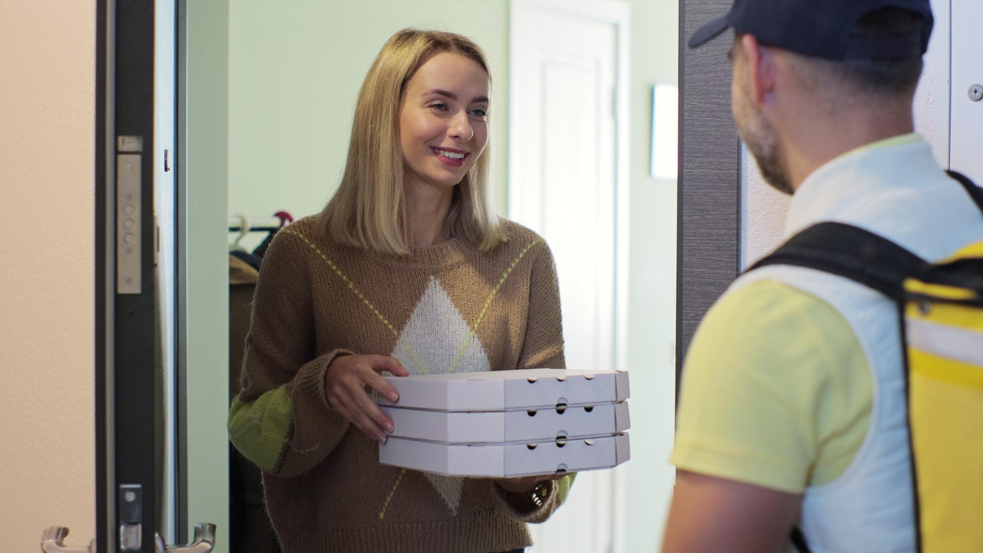 pizza-man-courier-is-delivering-order-woman-customer-inside-shot-food-delivery-concept-299057-1787.jpg
